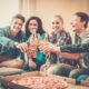friends giving cheers at pizza party